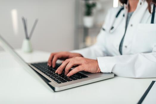 close-up-image-of-female-doctor-working-on-a-laptop-photo