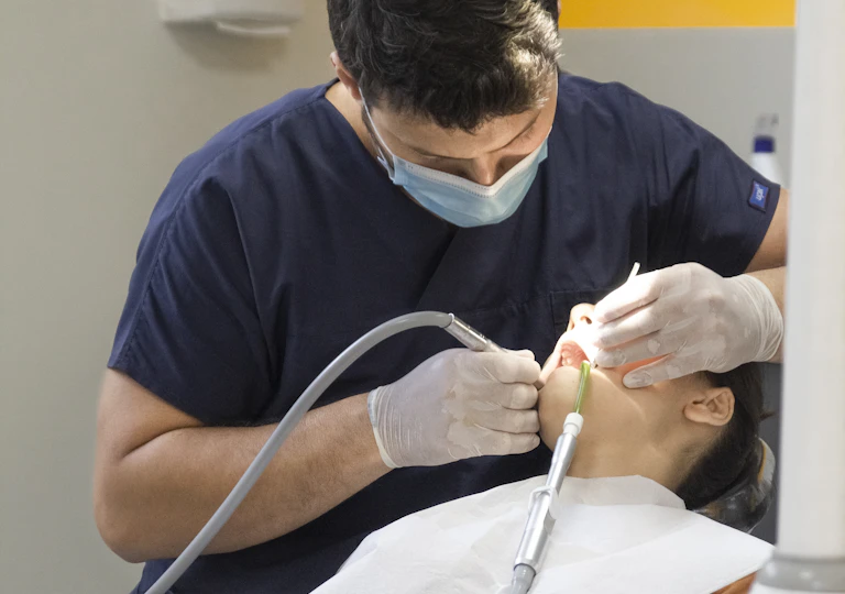 Dentist treating a patient in a dental practice